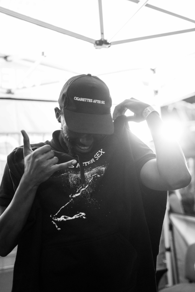 Man showing t-shirt, smiling